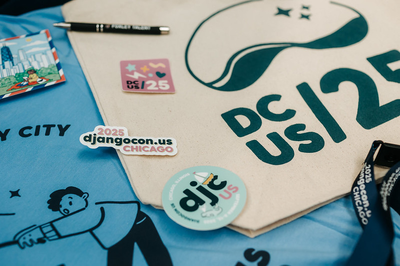 DjangoCon US 2025 swag including tote bag, stickers, t-shirt, and lanyard