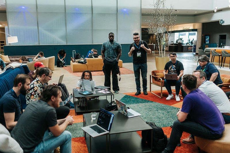 Attendees collaborating on laptops in the hotel lobby during sprints